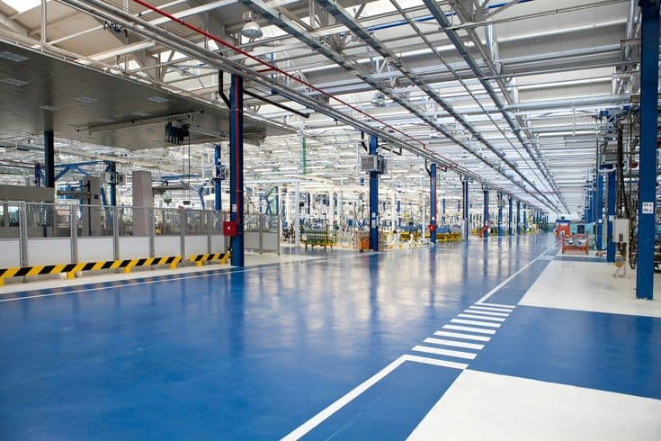 Glossy blue epoxy warehouse aisle with white lane borders