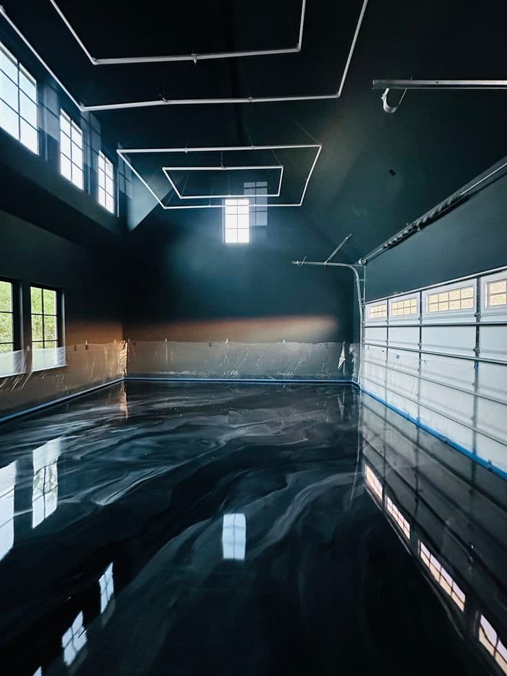 Metallic epoxy floor with mirror reflections in a dark showroom