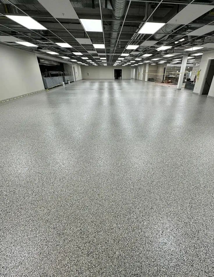 Expansive polished flake floor spanning a large commercial hall